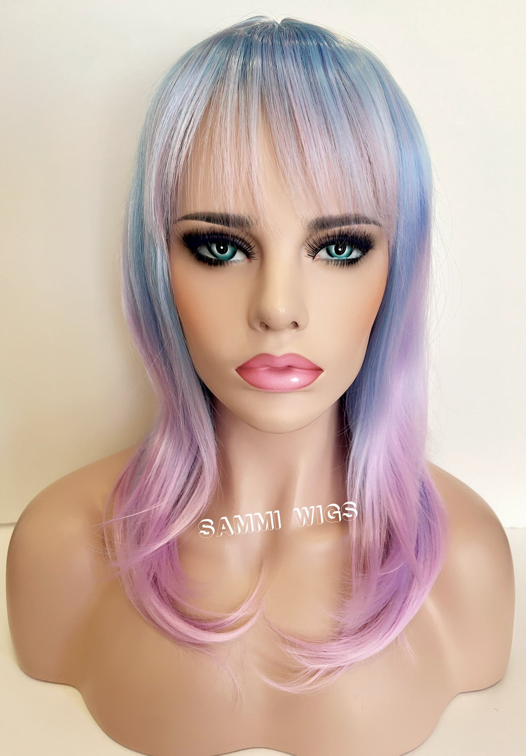 F730 Medium length wig with layers in paste blue ombré to pastel purple color