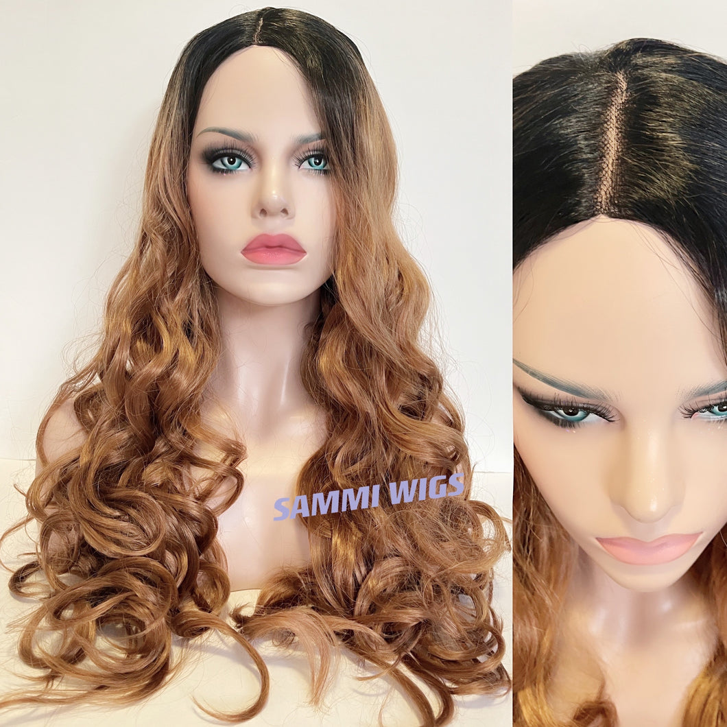 Extra long curly wig with hand made monofilament in parting section in ombré from black to warm dark blond color